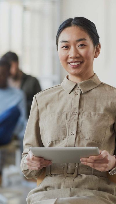 smiling-asian-businesswoman-at-seminar-NFUMTHF.jpg